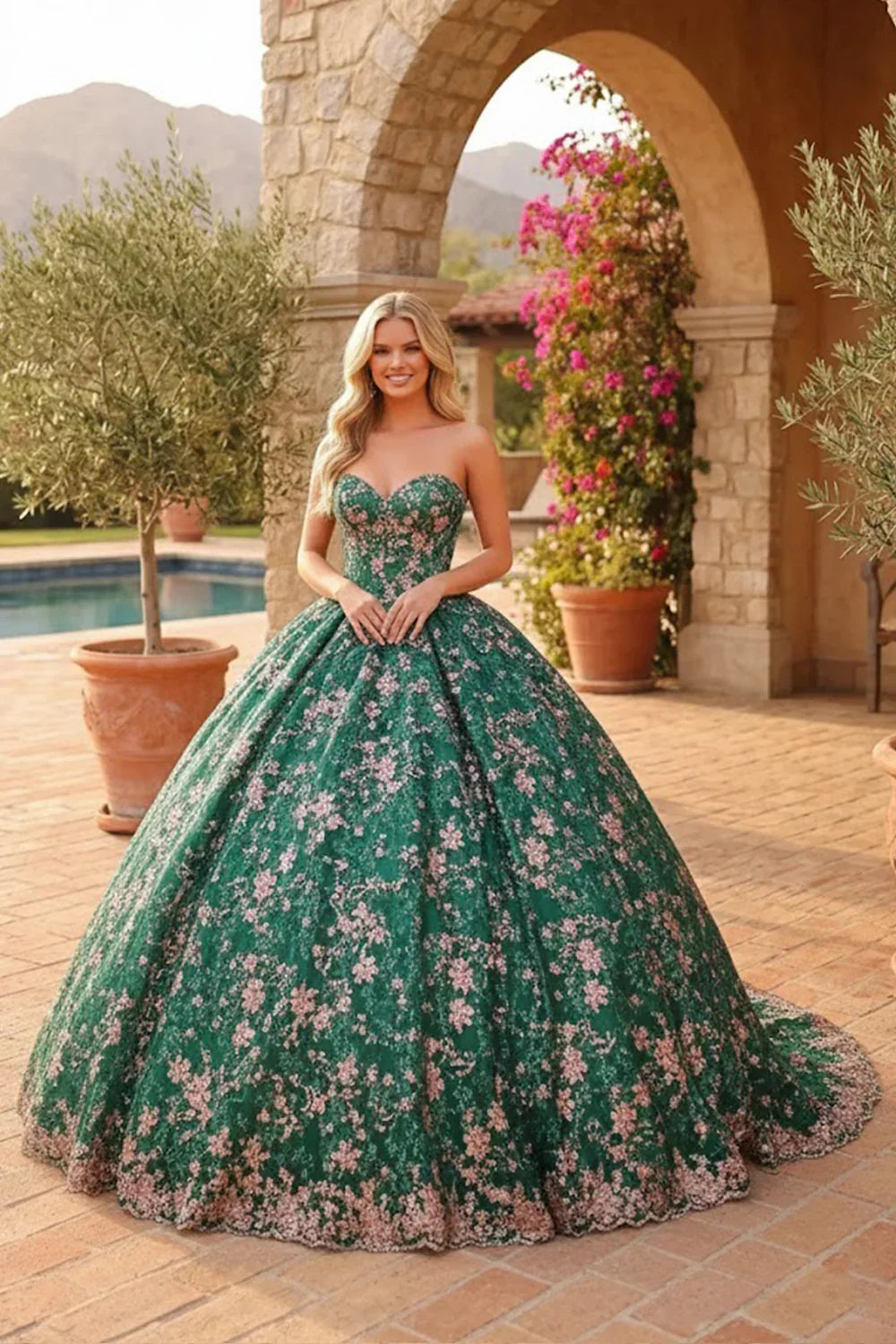 Green glitter ball gown quinceañera dress with pink floral embroidery, sleeveless, outdoors