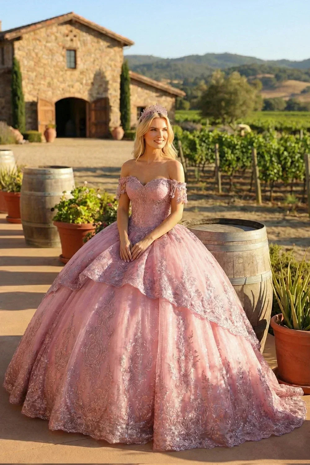 Woman in a pink floral appliqué off-shoulder ball gown dress outdoors by vineyard.