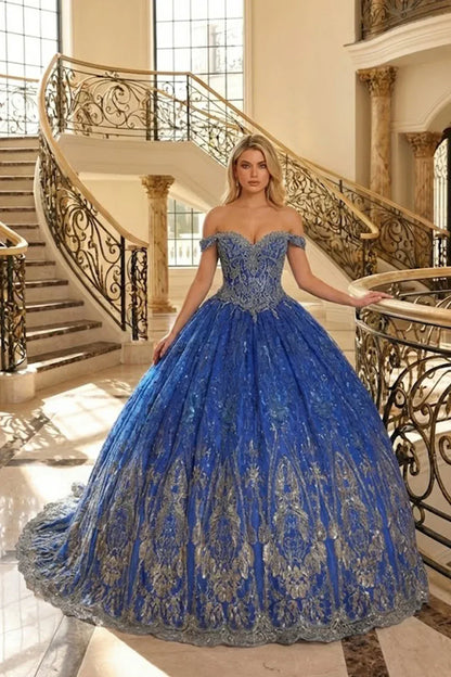 Woman in elegant blue off-the-shoulder ball gown with gold floral lace in grand staircase setting