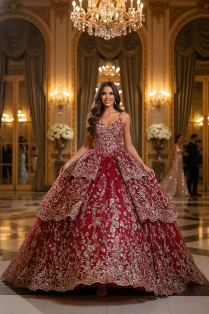 Woman in a red V-neck layered tulle ball gown with gold floral embroidery in a grand ballroom