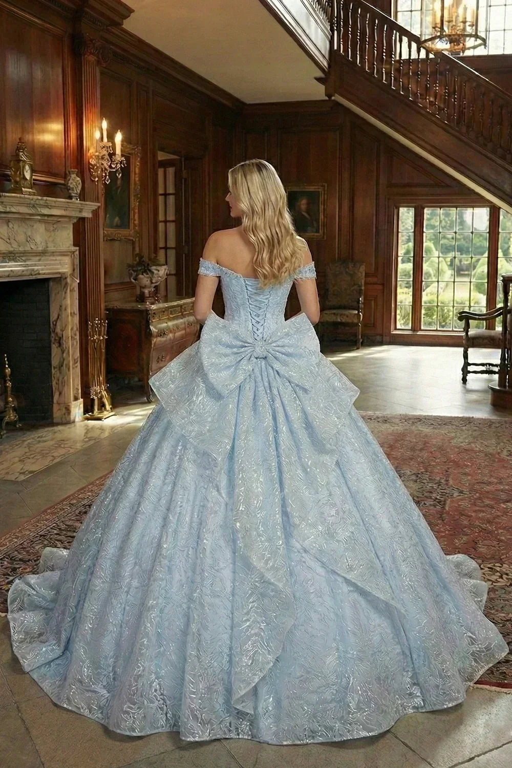 Woman in an elegant light blue off-shoulder ball gown with large bow and ruffled skirt