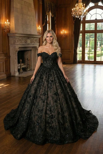 Woman in black off-shoulder ball gown with 3D floral details in elegant ballroom