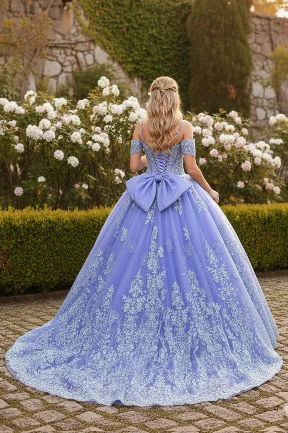Lavender ball gown with floral embroidery, large bow, and off-shoulder sleeves in garden setting