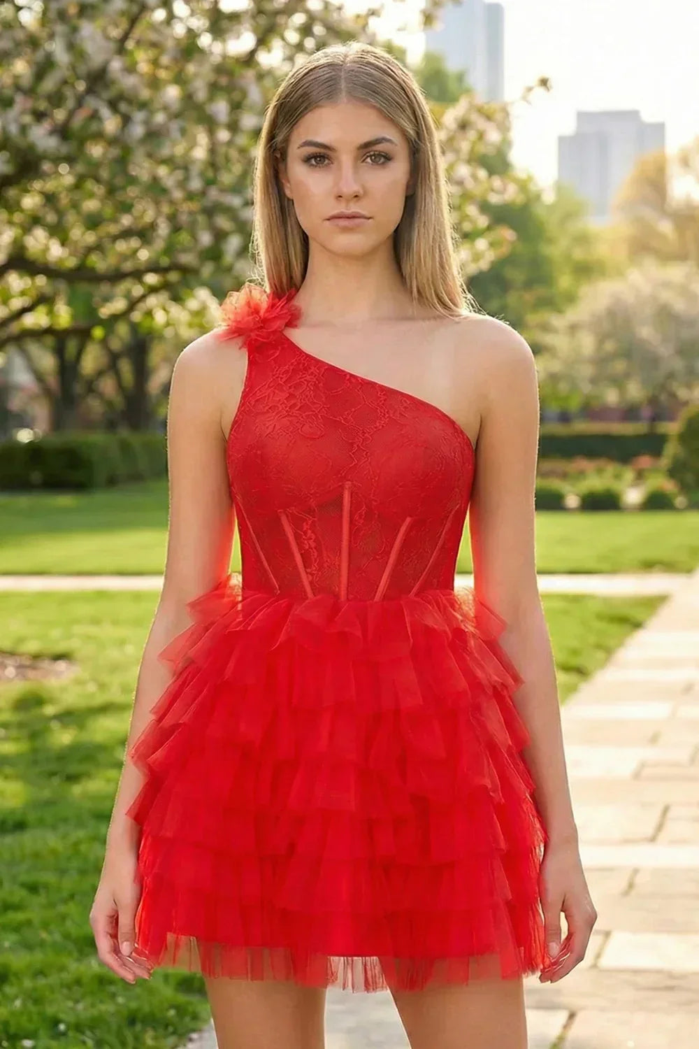 Woman in a one-shoulder red lace corset ruffle short homecoming dress with 3D flower detail