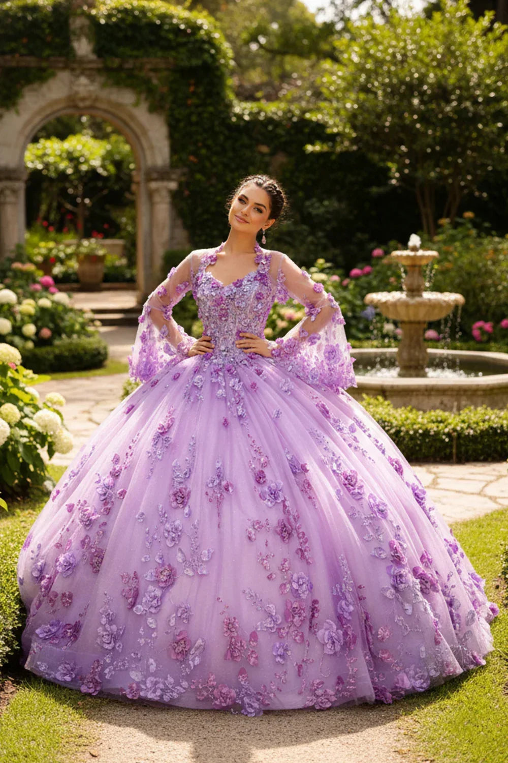 Young woman in a lavender ball gown with 3D floral lace detailing, posing in a garden by a fountain.