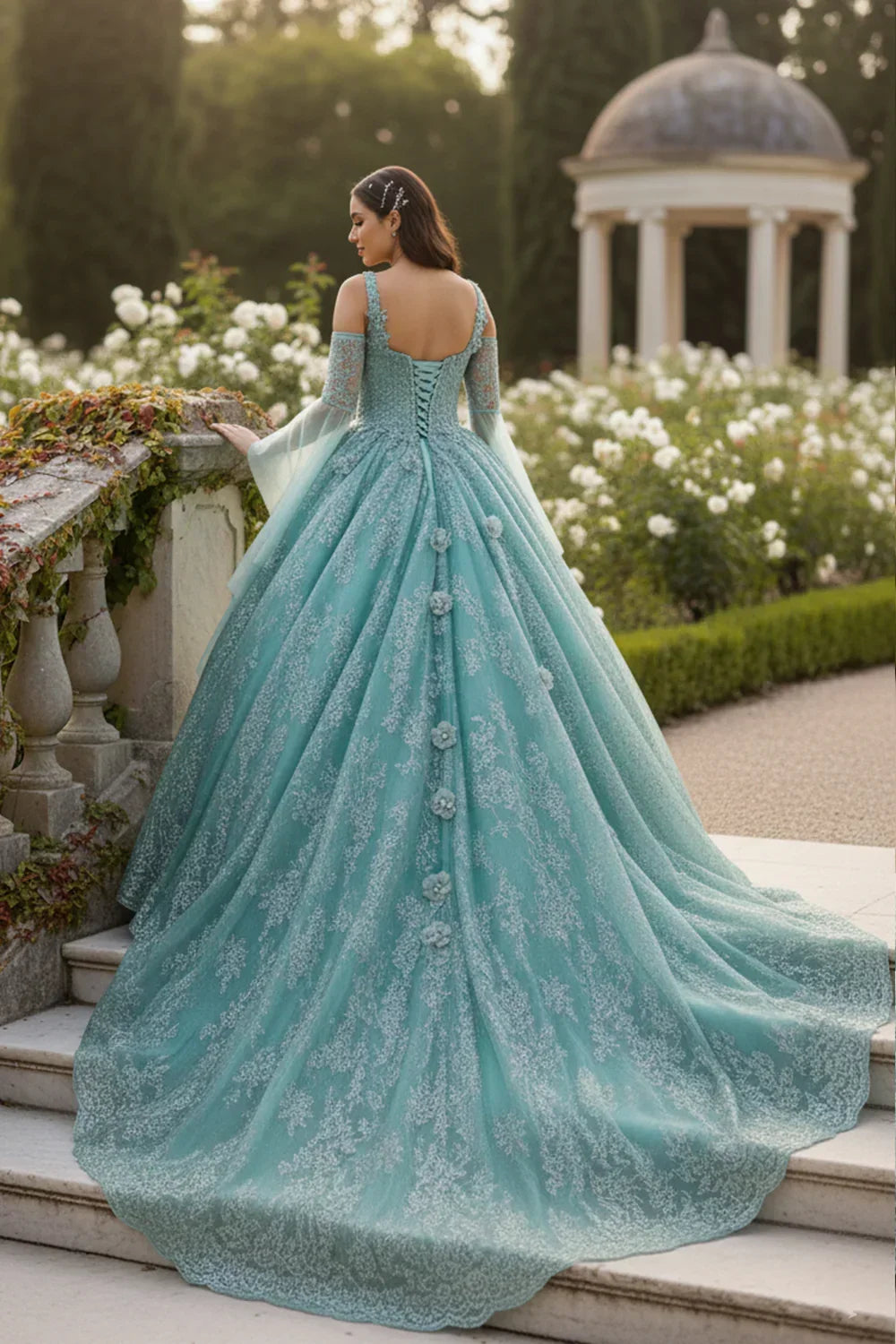 Elegant blue ball gown with floral embroidery and cold-shoulder design in a garden setting