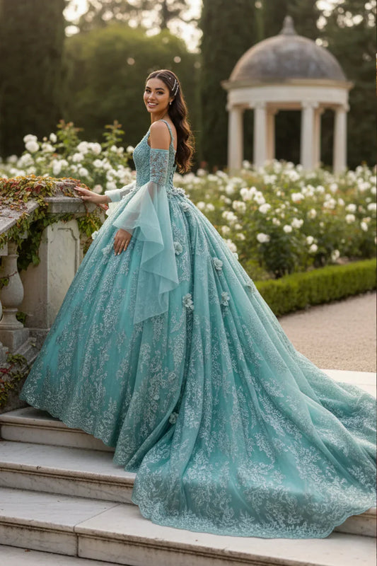 Woman in elegant teal ball gown with floral embroidery, cold shoulder design, in garden setting