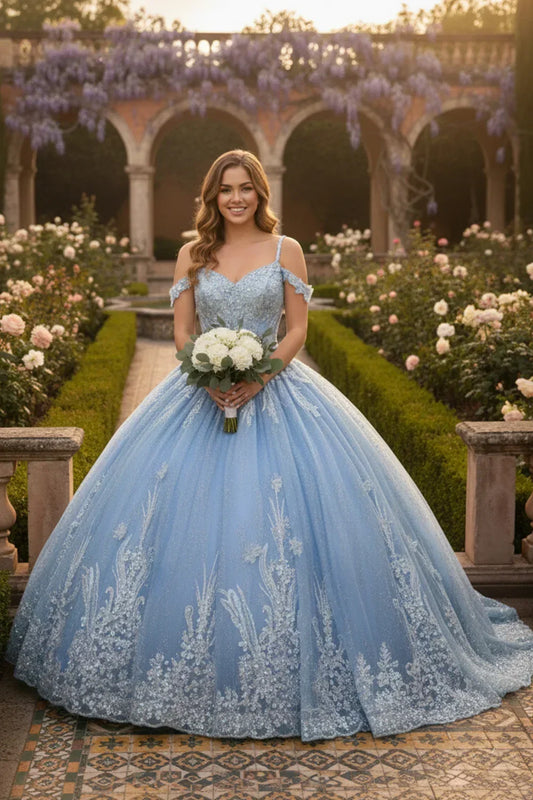 Woman in a blue off-shoulder lace quinceañera ball gown with embroidery, holding bouquet in a garden