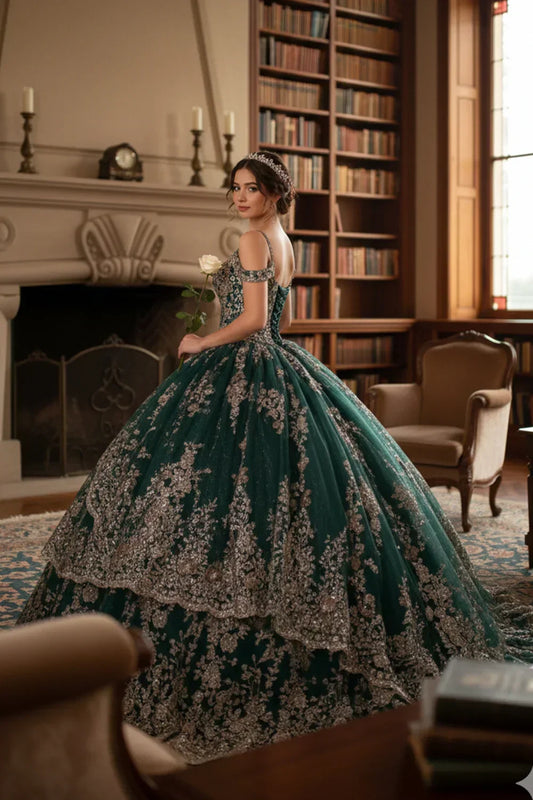 Elegant woman in emerald green glitter ball gown with lace, holding a rose in a library