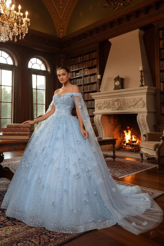 Woman in a light blue off-shoulder ball gown with 3D floral details in a grand library