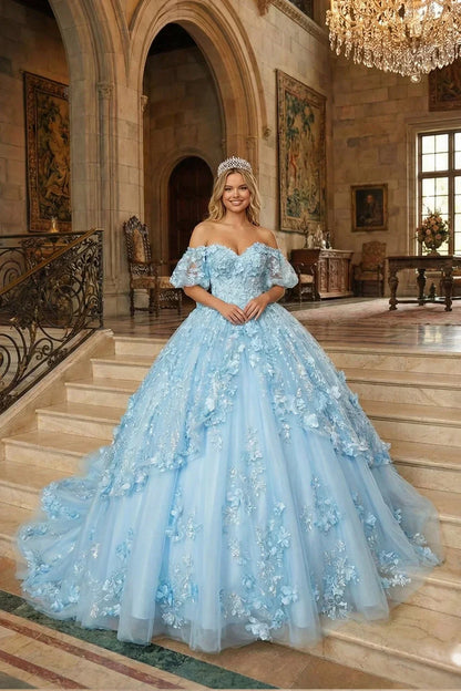 Woman in blue textured ruffle ball gown with floral applique, V-neck, and tiara in elegant hall