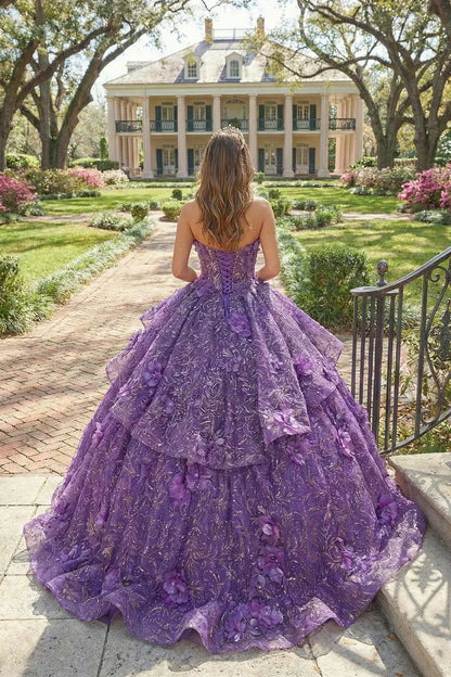 Woman in a purple textured ruffle ball gown with 3D floral details standing outdoors